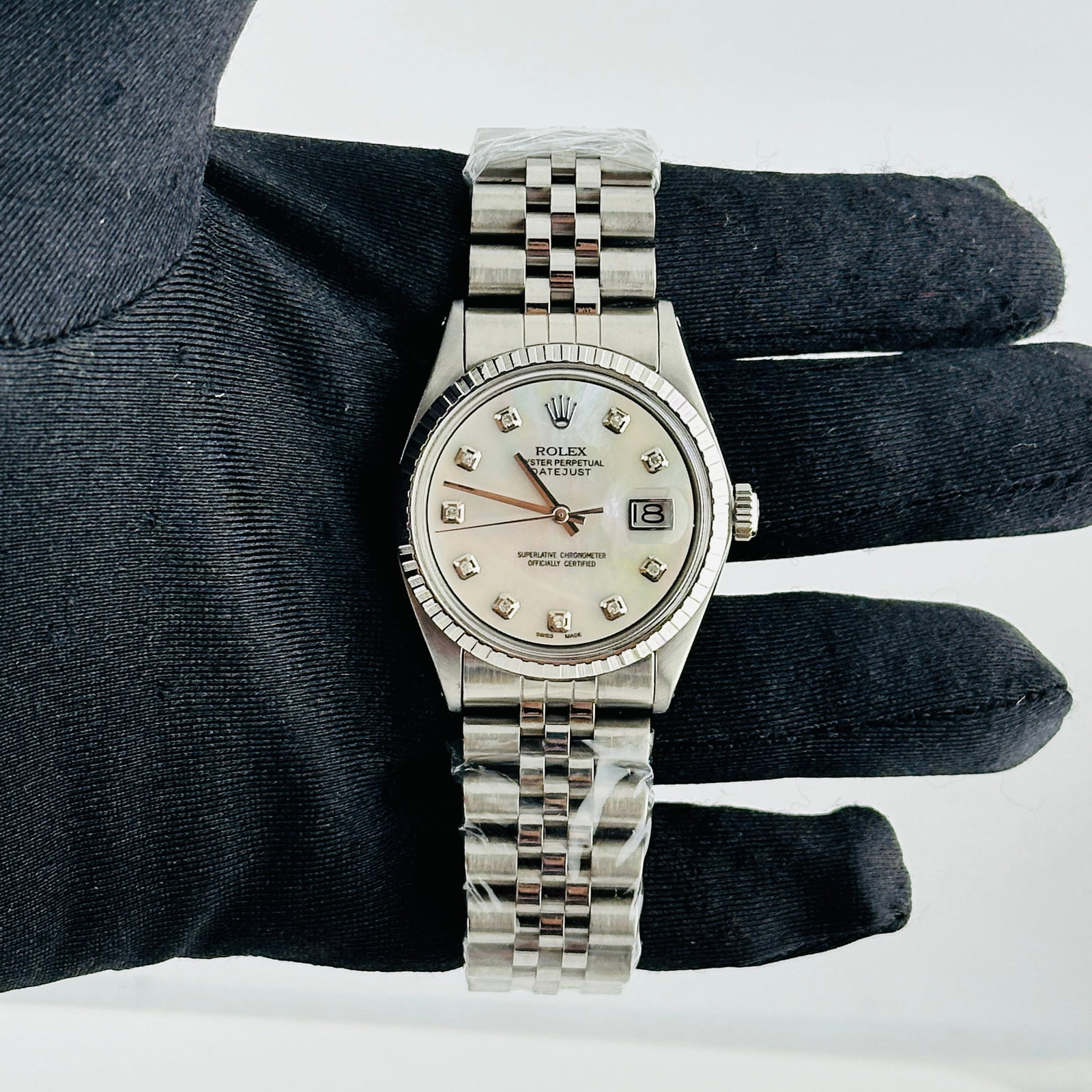 Rolex Datejust Reference 1601-3 Men's Watch With Aftermarket MOP Diamond Dial Jubilee: Rolex Datejust Reference 1601-3 Men's Watch With Aftermarket MOP Diamond Dial Jubilee This Rolex Datejust features a white mother-of-pearl dial set with diamond markers, complemented by an engine-turn