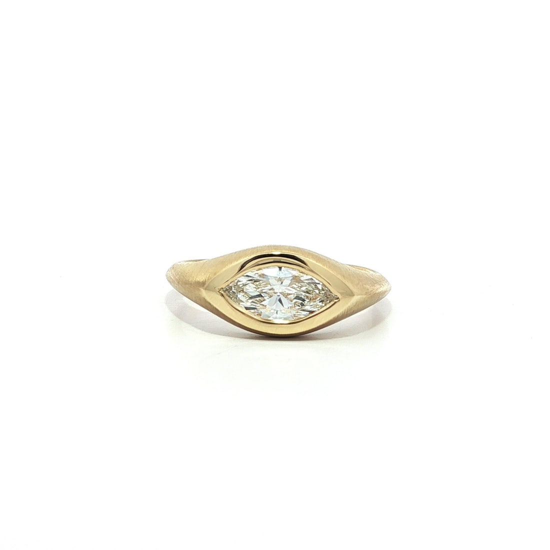 18k Yellow Gold GIA .70ct Marquise Bezel Diamond E-W Band Ring: 18k Yellow Gold GIA .70ct Marquise Bezel Diamond E-W Band Ring This exquisite 18k yellow gold band ring features a stunning marquise cut diamond, weighing 0.70ct, beautifully set in a bezel design. Th