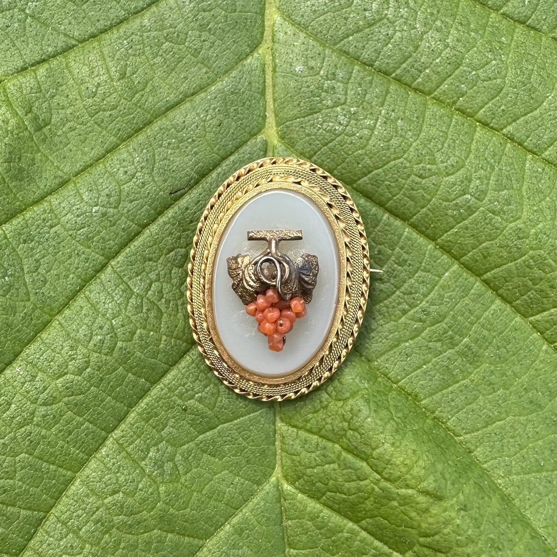 Antique 18k Yellow Gold Brooch with Coral Beads and White Hardstone: Antique 18k Yellow Gold Brooch with Coral Beads and White Hardstone Antique handmade grape bunch brooch featuring a white hardstone centerpiece accented by numerous natural genuine coral beads. The pi