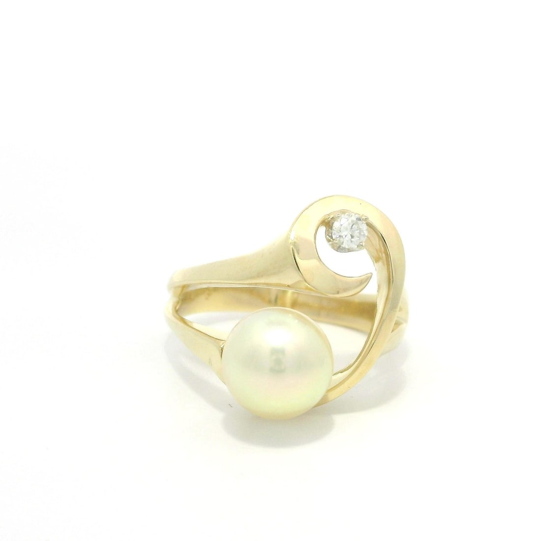14k Yellow Gold Abstract Open Ring with Diamond and Pearl: 14k Yellow Gold Abstract Open Ring with Diamond and Pearl This exquisite cocktail ring features a modern abstract design crafted from solid 14k yellow gold. It showcases a natural diamond and a cultur