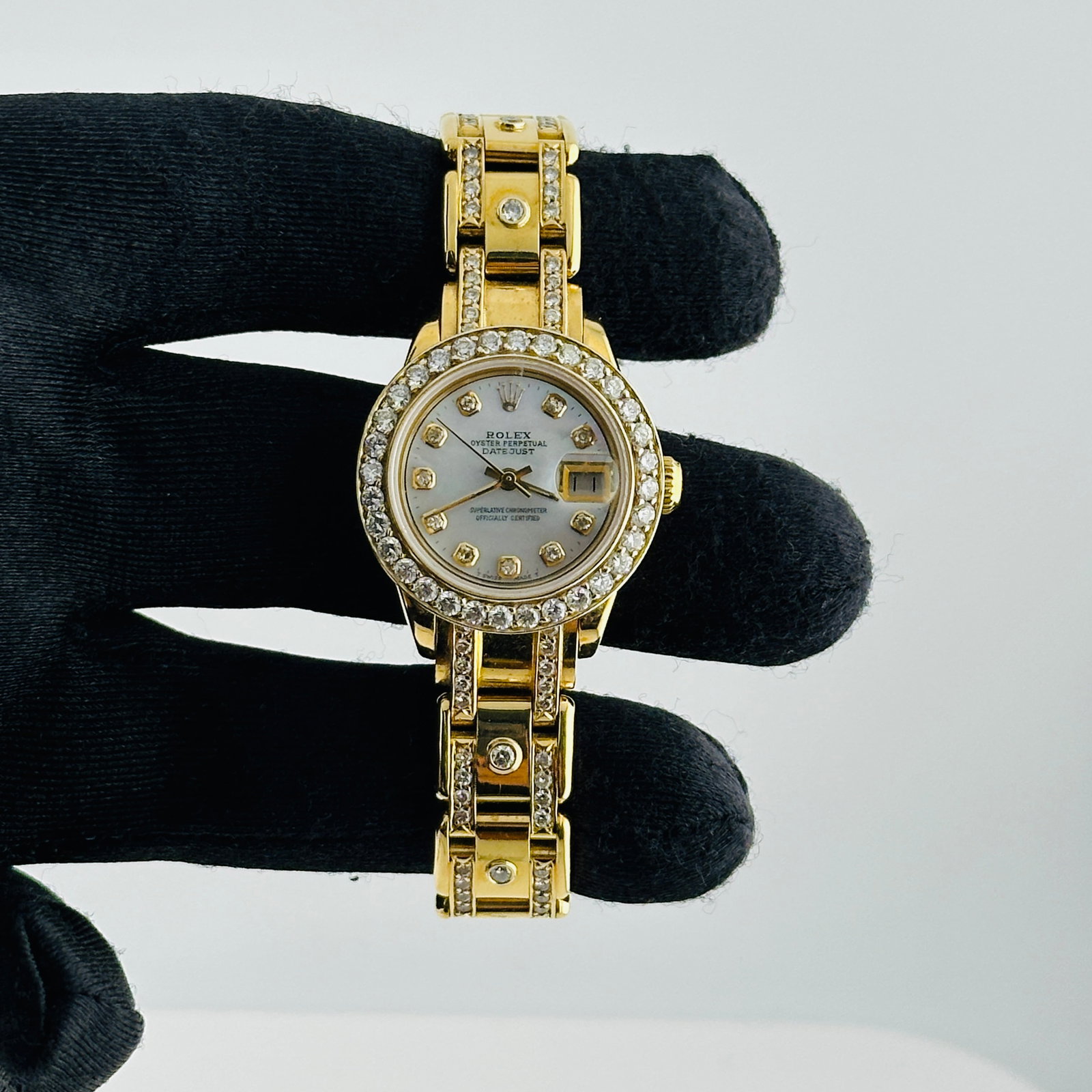 Ladies Rolex Datejust Pearlmaster Bracelet Diamond Bezel Ref 6916: Ladies Rolex Datejust Pearlmaster Bracelet Diamond Bezel Ref 6916 This ladies' Rolex Datejust features an aftermarket white mother of pearl dial with yellow diamond markers, complemented by a diamond 
