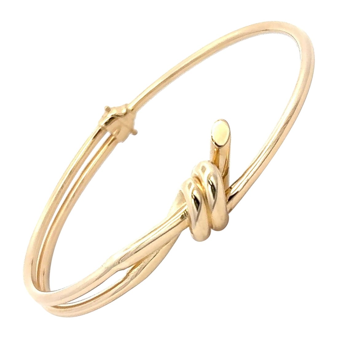 14K Yellow Gold Bangle Bracelet with Knot Design 8.4g: 14K Yellow Gold Bangle Bracelet with Knot Design 8.4g This minimalist bangle bracelet is crafted from 14K yellow gold and features a classic knot design, symbolizing unity and enduring style. The poli