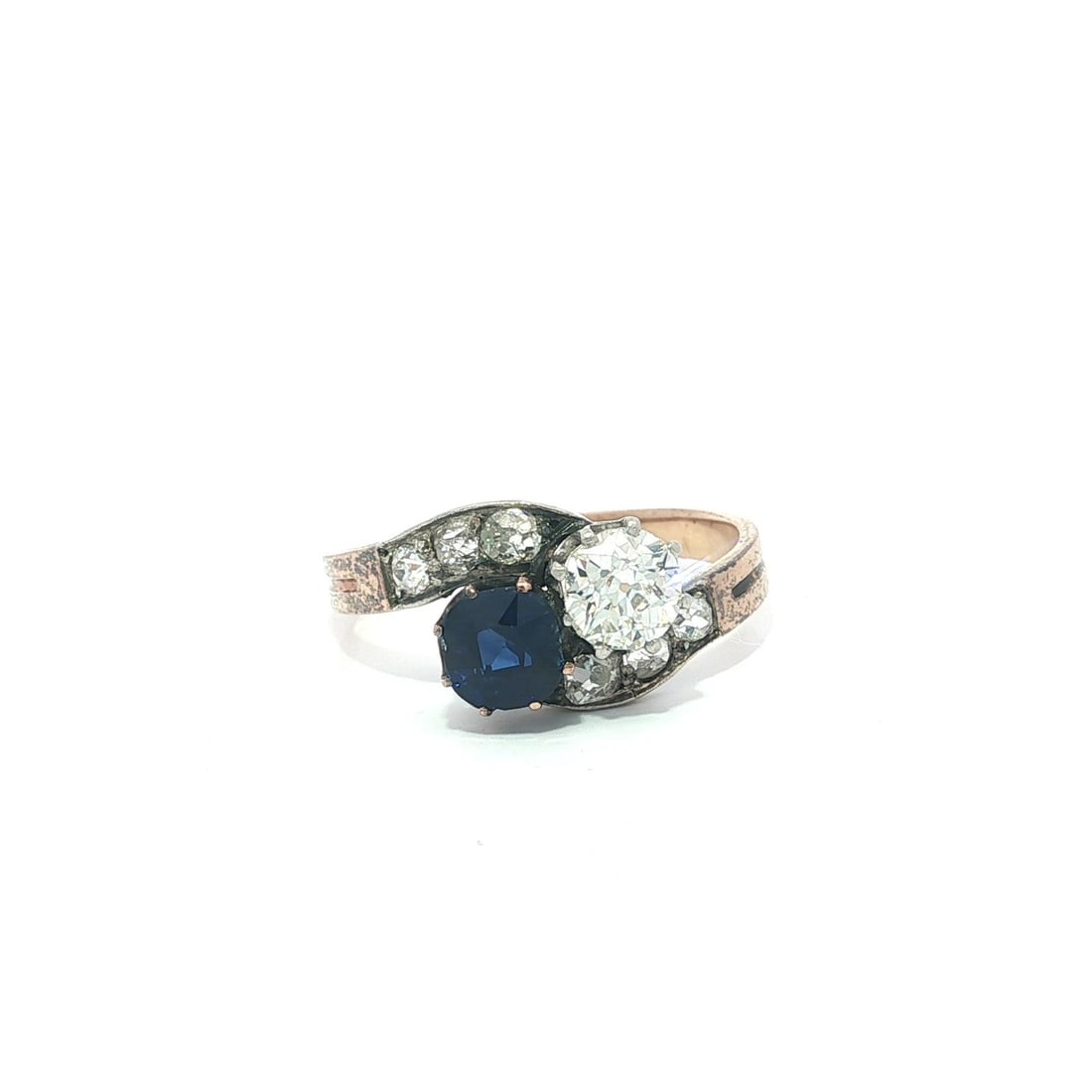 Edwardian Yellow Gold Silver Sapphire and Diamond GIA Certified Antique Bypass Ring: Edwardian Yellow Gold Silver Sapphire and Diamond GIA Certified Antique Bypass Ring This antique Edwardian bypass ring features a natural, GIA-certified sapphire of deep royal blue color, set alongsid