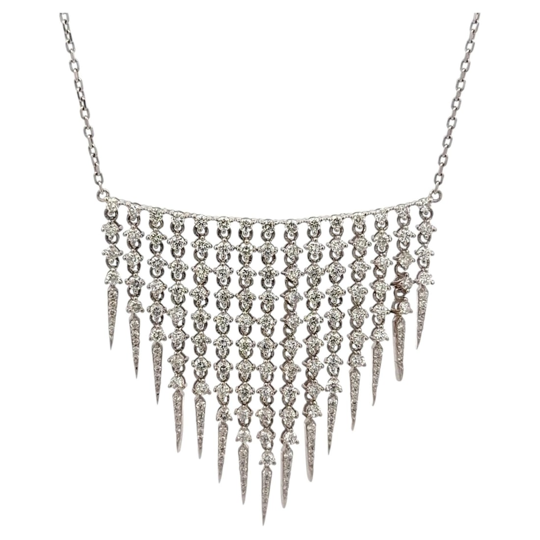 Diamond fringe bib necklace in 18k white gold 3.76 carats: Diamond fringe bib necklace in 18k white gold 3.76 carats This contemporary bib necklace is expertly crafted from 18K white gold and features a dramatic fringe tassel design. The piece is adorned with