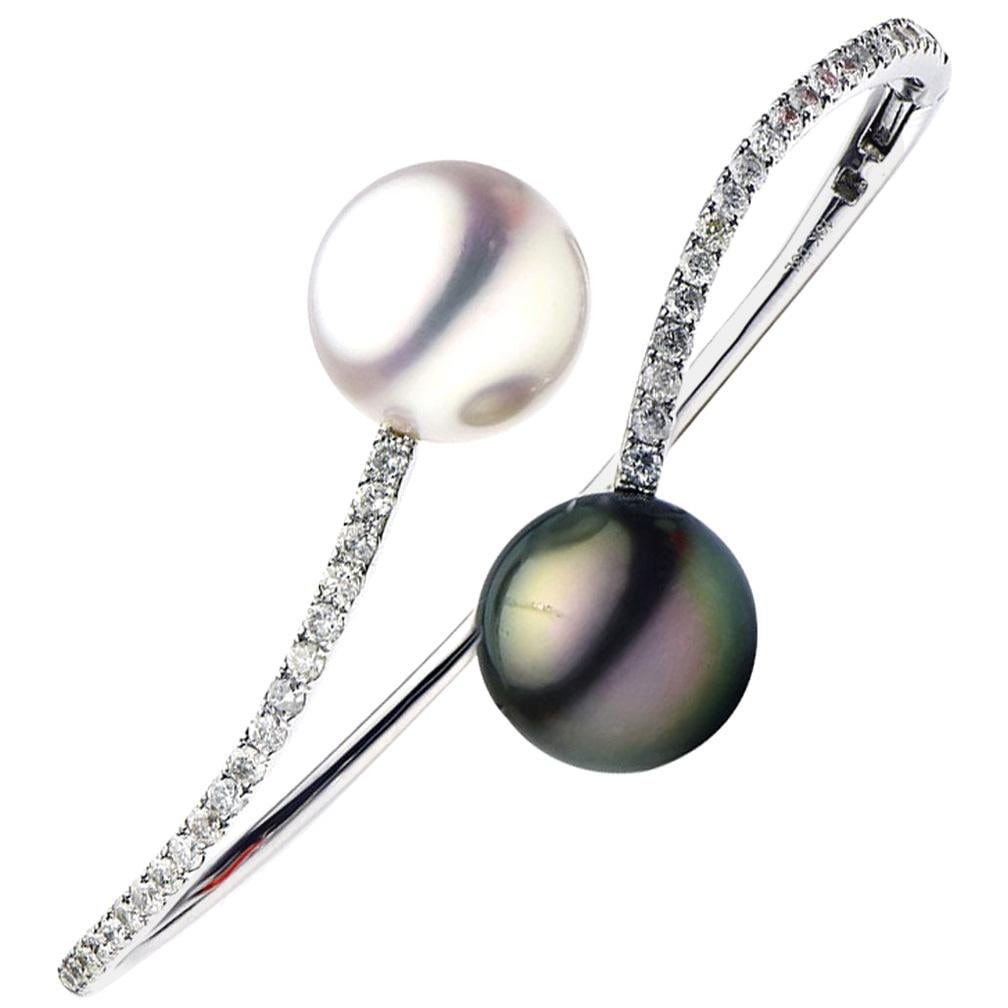 18K White Gold South Sea Pearl Tahitian Diamond Bypass Bracelet 1.03 CTTW: 18K White Gold South Sea Pearl Tahitian Diamond Bypass Bracelet 1.03 CTTW This stunning bypass bangle bracelet is crafted from luxurious 18k white gold and features a contemporary design. Adorned with