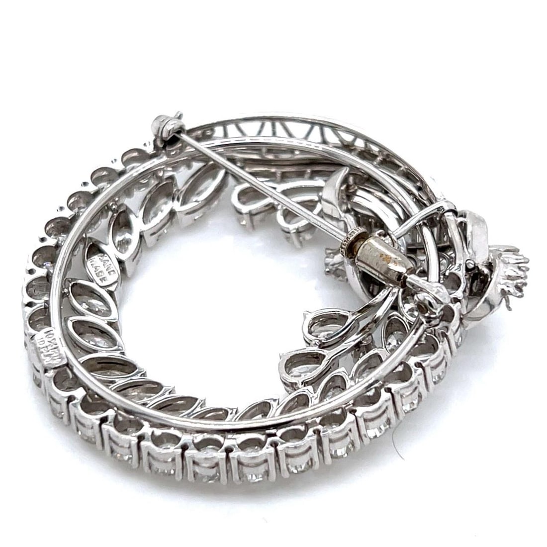 1960's Platinum Diamond Brooch 12.00 Ct with 31 Round Diamonds: 1960's Platinum Diamond Brooch 12.00 Ct with 31 Round Diamonds This exquisite 1960's Platinum brooch showcases a stunning arrangement of diamonds, weighing a total of 12.00 Ct. The piece features 31 r