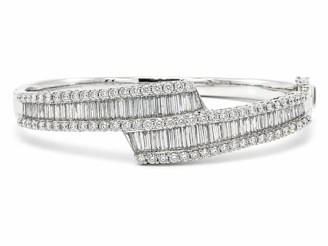 14k White Gold Diamond Hinged Bangle 6.08ctw 6.75 in: 14k White Gold Diamond Hinged Bangle 6.08ctw 6.75 in This elegant hinged bangle bracelet is crafted from solid 14k white gold and features a stunning arrangement of natural, genuine diamonds. The desi