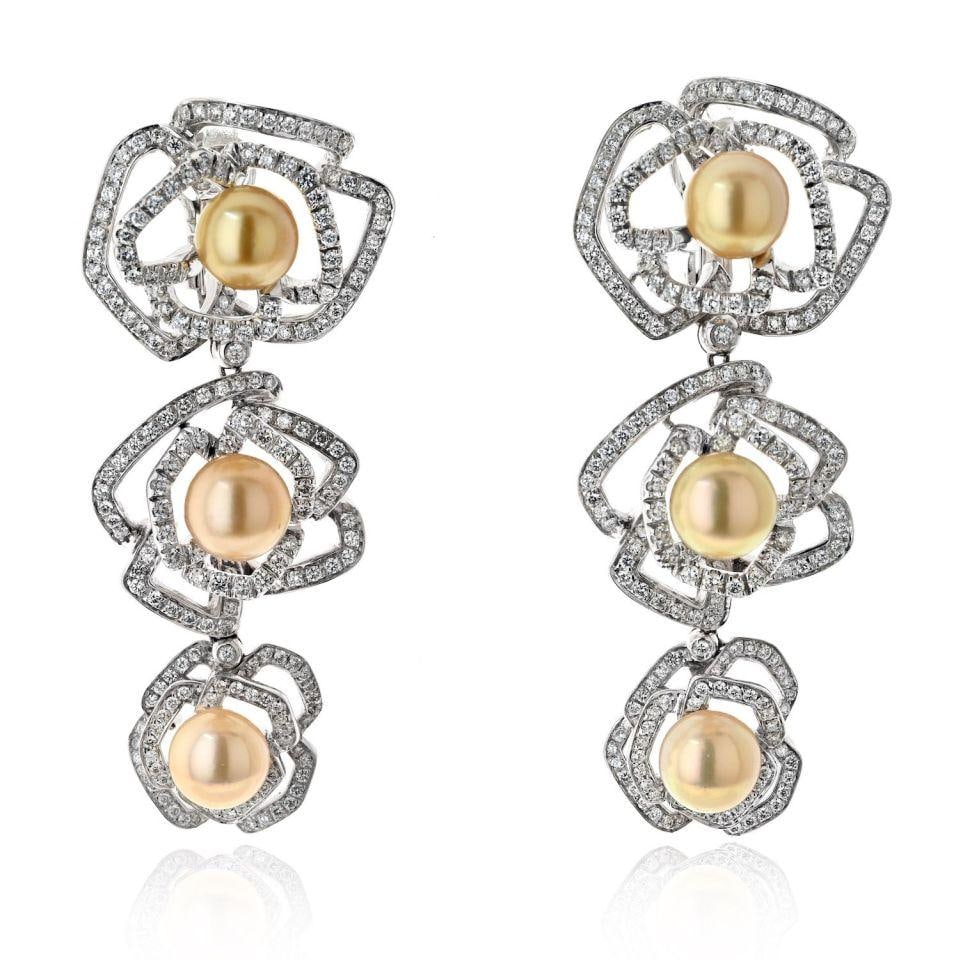 18K White Gold Floral Pearl Drop Earrings with Diamonds: 18K White Gold Floral Pearl Drop Earrings with Diamonds Elevate your elegance with these stunning 18K White Gold Triple Pearl Floral Motif Diamond Drop Earrings. These exquisite clip-on earrings featu