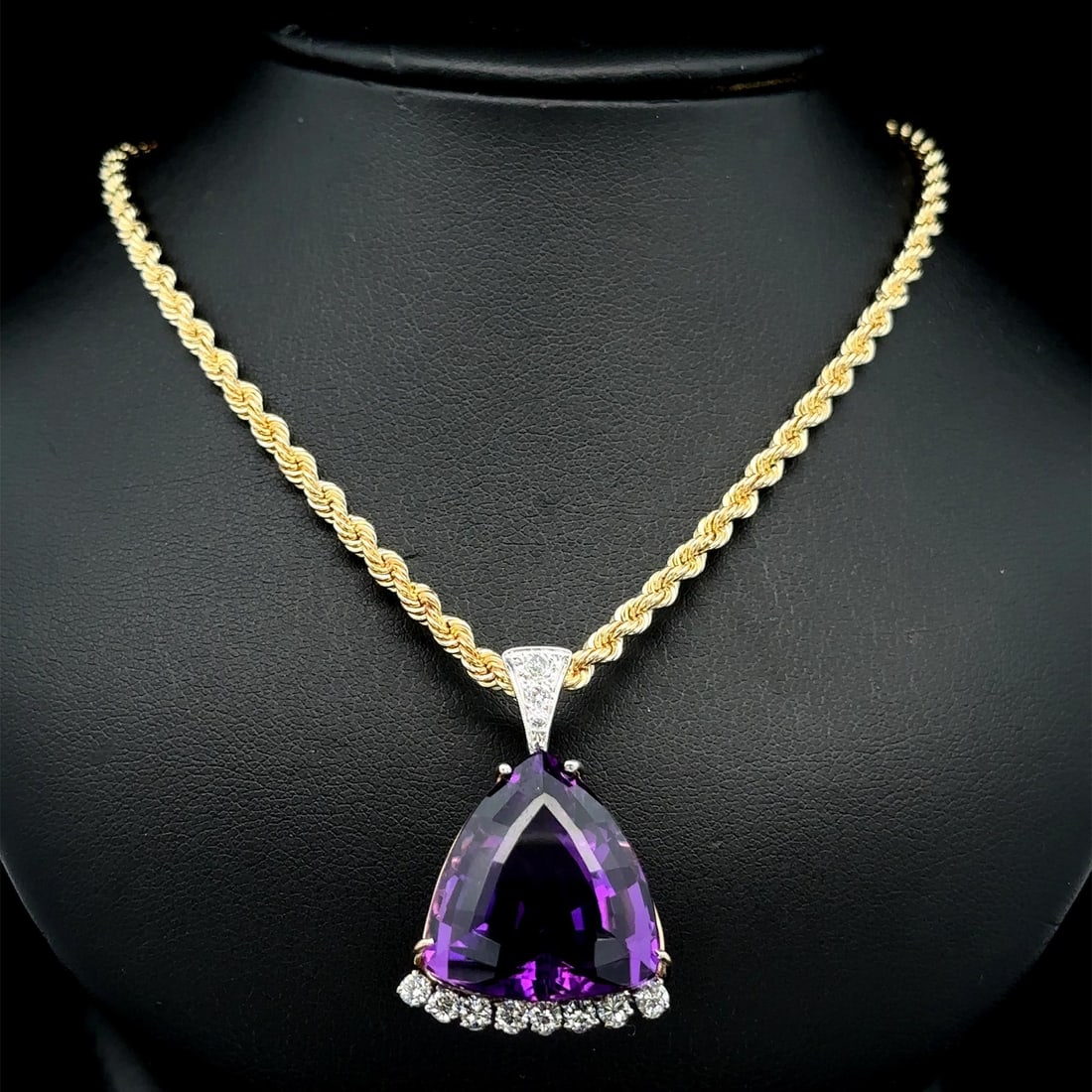 Vintage 14k Yellow Gold Amethyst Diamond Pendant Necklace: Vintage 14k Yellow Gold Amethyst Diamond Pendant Necklace This exquisite vintage pendant necklace features a stunning trillion cut amethyst, prong set to showcase its deep purple hue. Accompanying the