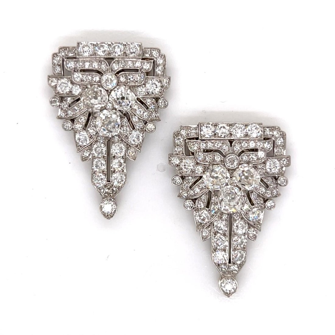 Art Deco Platinum Diamond Clips by Wedderien with Old Mine Diamonds: Art Deco Platinum Diamond Clips by Wedderien with Old Mine Diamonds This pair of Art Deco platinum diamond clips features a total of 156 old mine cut diamonds. Six of the diamonds weigh approximately 