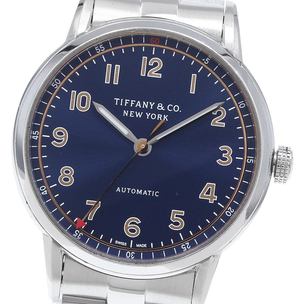 Tiffany Co CT60 Mens Automatic Wristwatch Ref 34668337: Tiffany Co CT60 Mens Automatic Wristwatch Ref 34668337 Pre-owned Tiffany & Co. CT60 automatic men's wristwatch with a navy dial and stainless steel case and bracelet. This watch-only offering shows vi