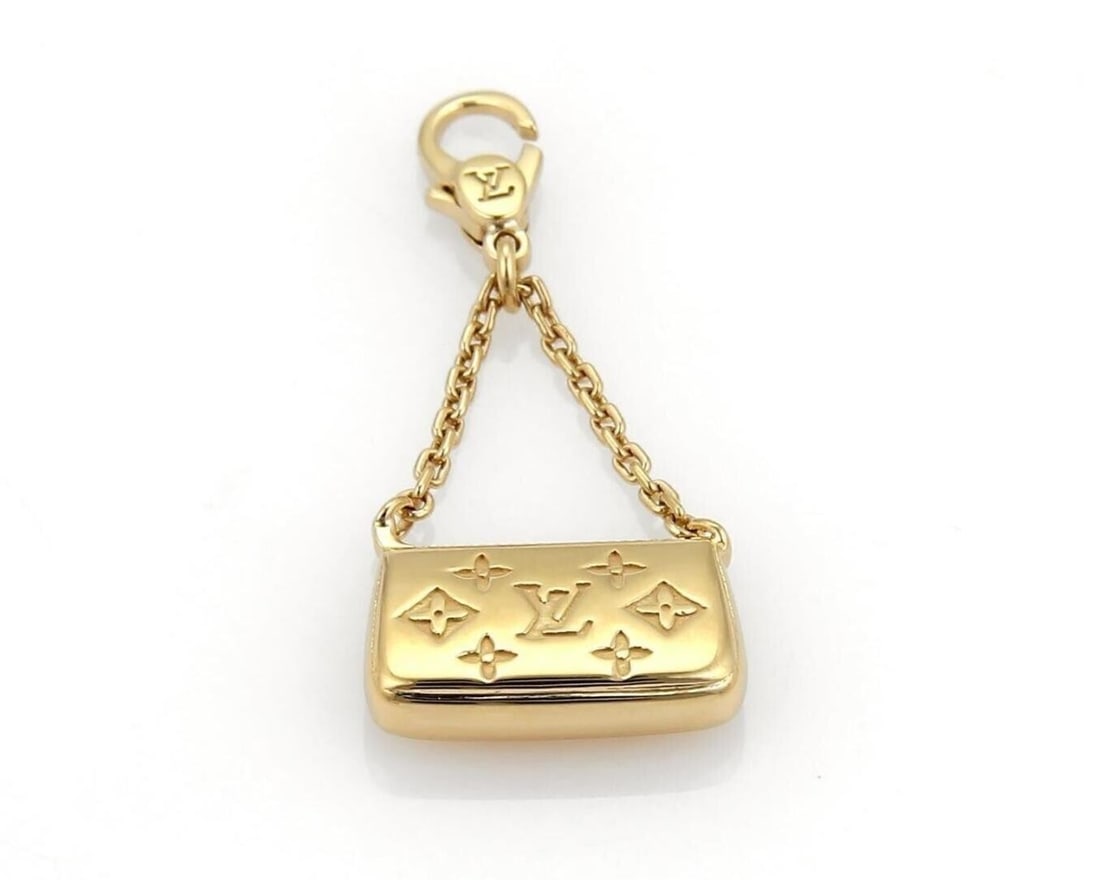 Louis Vuitton 18k Yellow Gold Mini Clutch Charm Pendant: Louis Vuitton 18k Yellow Gold Mini Clutch Charm Pendant Authentic Louis Vuitton mini clutch charm pendant crafted in solid 18k yellow gold. This signed piece features a miniature clutch purse design w