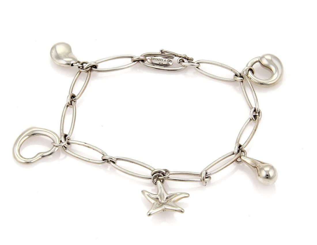 Tiffany Co Elsa Peretti Sterling Silver Oval Chain Bracelet with 5 Charms: Tiffany Co Elsa Peretti Sterling Silver Oval Chain Bracelet with 5 Charms Vintage Tiffany & Co. Elsa Peretti five charms oval chain bracelet in sterling silver. This signed bracelet features an oval-l