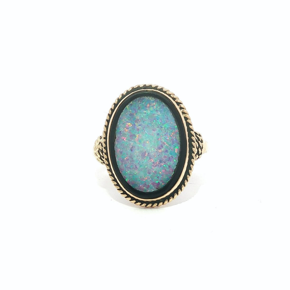 Opal and Black Onyx Cocktail Ring in 14k Yellow Gold Twisted Frame: Opal and Black Onyx Cocktail Ring in 14k Yellow Gold Twisted Frame This vintage cocktail ring features a natural oval-cut opal inlaid in black onyx, set within a twisted wire frame of solid 14k yellow