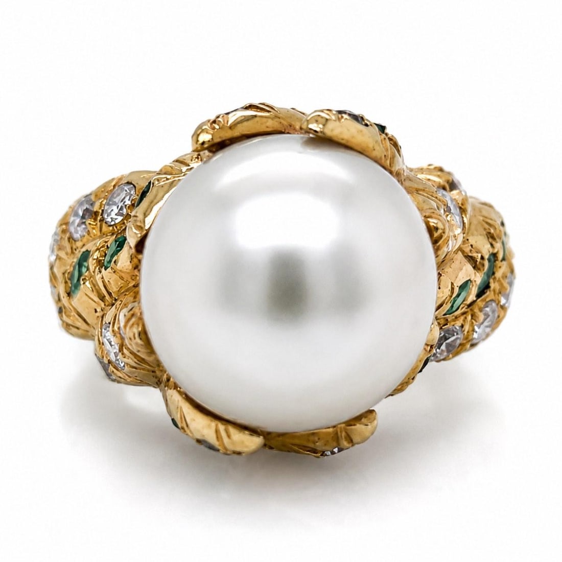 South Sea Pearl Ring in 18K Yellow Gold with Diamonds and Emeralds: South Sea Pearl Ring in 18K Yellow Gold with Diamonds and Emeralds This elegant ring is crafted from 18K yellow gold and features a luxurious South Sea pearl as its centerpiece. The design is accented