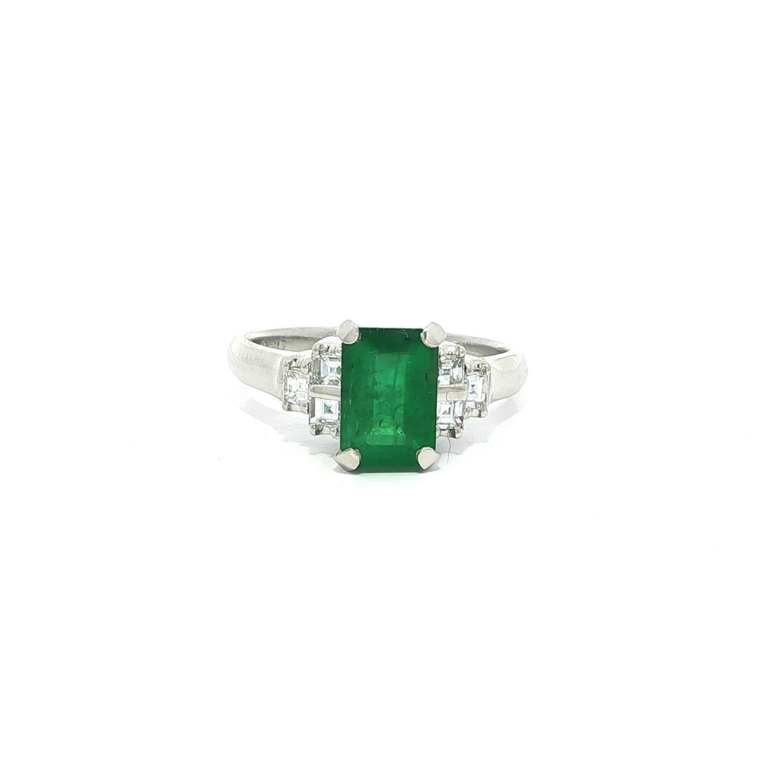 Emerald Cut Green Emerald Platinum Ring with Diamond Sides Size 6: Emerald Cut Green Emerald Platinum Ring with Diamond Sides Size 6 This platinum ring features a striking natural emerald in a rich green hue, expertly cut in an elongated emerald shape and prong set a