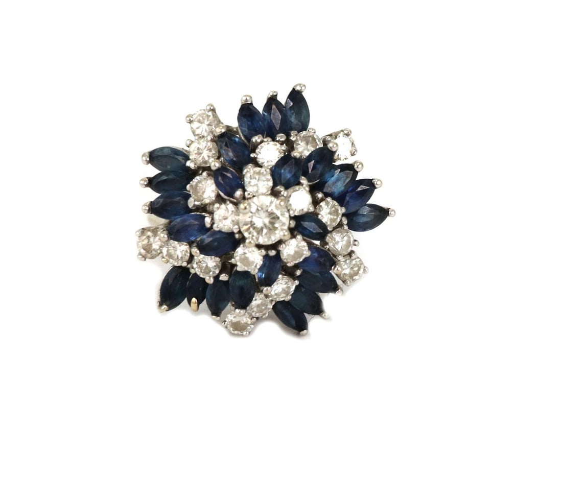 Estate 14k White Gold Swirl Ring with Diamonds and Sapphires: Estate 14k White Gold Swirl Ring with Diamonds and Sapphires This exquisite Estate cluster ring is designed in 14k white gold, showcasing a captivating swirl design. The ring features alternating marq