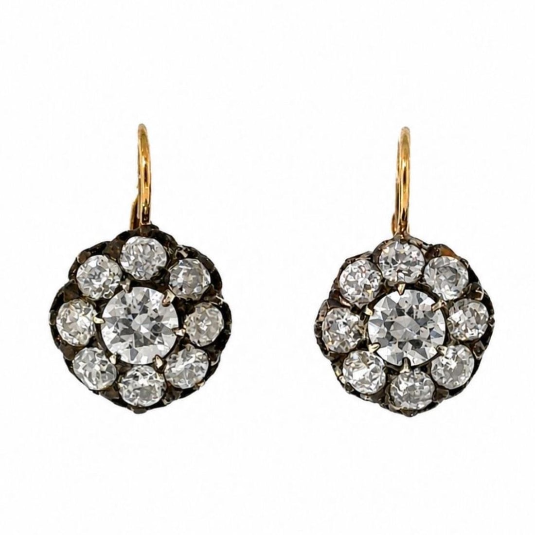 Diamond Cluster Earrings in 18K Yellow Gold and Silver: Diamond Cluster Earrings in 18K Yellow Gold and Silver Pre-owned diamond cluster earrings crafted in 18K yellow gold and silver. The earrings feature 2 diamonds and 16 old mine diamonds in a classic c
