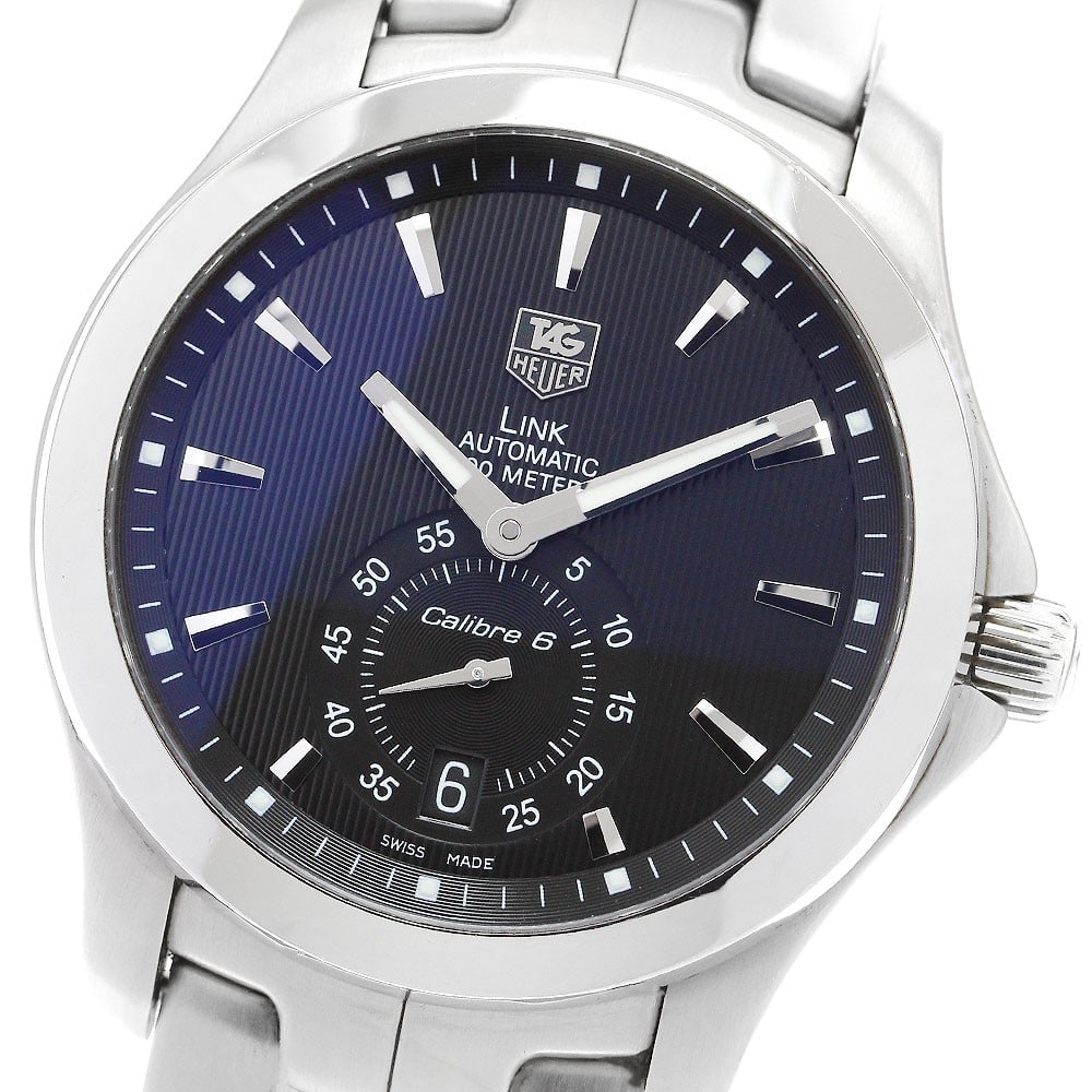 TAG Heuer Link Caliber 6 automatic date men's stainless steel watch: TAG Heuer Link Caliber 6 automatic date men's stainless steel watch This TAG Heuer Link Caliber 6 Date Automatic men's wristwatch features a stainless steel case and band with a black dial. The watch 