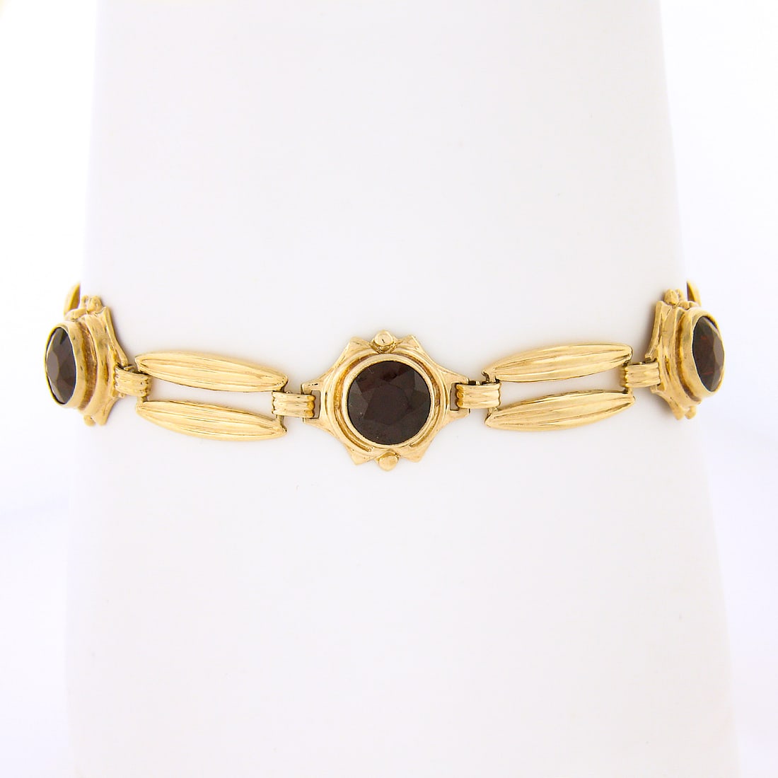Retro 14K Yellow Gold Garnet Bracelet with Grooved Bullet Links 6.75": Retro 14K Yellow Gold Garnet Bracelet with Grooved Bullet Links 6.75" Vintage retro bracelet crafted in solid 14k yellow gold with a dual row grooved bullet link design and three bezel-set natural gar