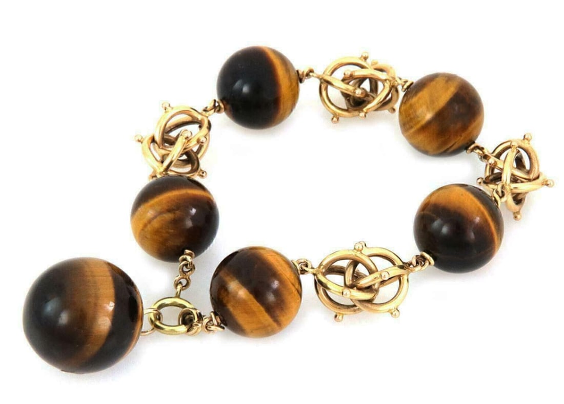 14k Yellow Gold Tiger's Eye Beaded Bracelet with Triple Links 9": 14k Yellow Gold Tiger's Eye Beaded Bracelet with Triple Links 9" Estate tiger's eye statement bead bracelet crafted in solid 14k yellow gold. The design features large natural tiger's eye beads accent