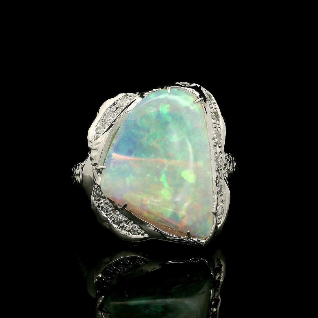 Platinum Cocktail Ring with Fiery Opal and Diamond Nugget Design: Platinum Cocktail Ring with Fiery Opal and Diamond Nugget Design This exquisite cocktail ring features a stunning natural fiery opal at its center, showcasing a white base with vibrant red and orange 