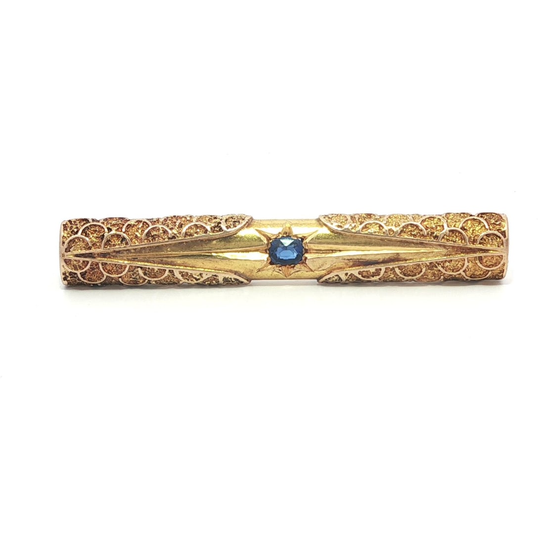 Victorian Era Yellow Gold Bar Pin with Old Mine Cushion Sapphire: Victorian Era Yellow Gold Bar Pin with Old Mine Cushion Sapphire This antique Victorian bar pin features a natural old mine cushion cut sapphire in a striking blue hue. The ornate and detailed design 