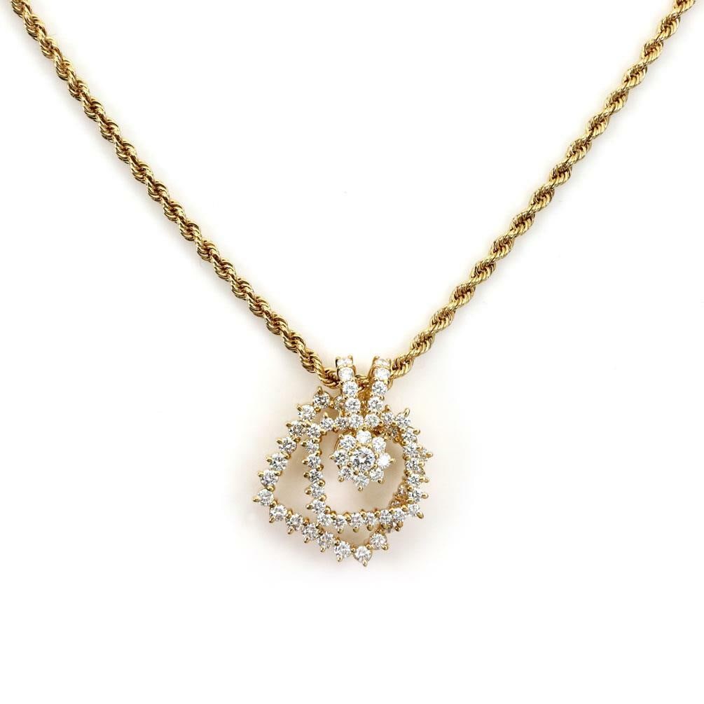Movado 18k Gold Diamond Pendant 2 Tier Spinner with Chain: Movado 18k Gold Diamond Pendant 2 Tier Spinner with Chain This exquisite Movado pendant and chain set showcases a stunning design crafted from 18k yellow gold with a polished finish. The pendant
