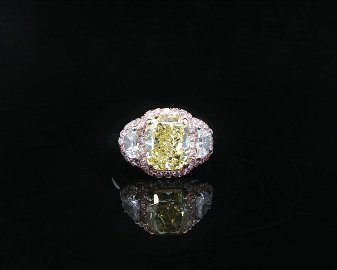 GIA Fancy Intense Yellow Cushion Diamond Pink Halo Platinum Ring: GIA Fancy Intense Yellow Cushion Diamond Pink Halo Platinum Ring This custom cocktail ring features a stunning 3.03 carat GIA-certified natural fancy intense yellow cushion modified brilliant cut diam