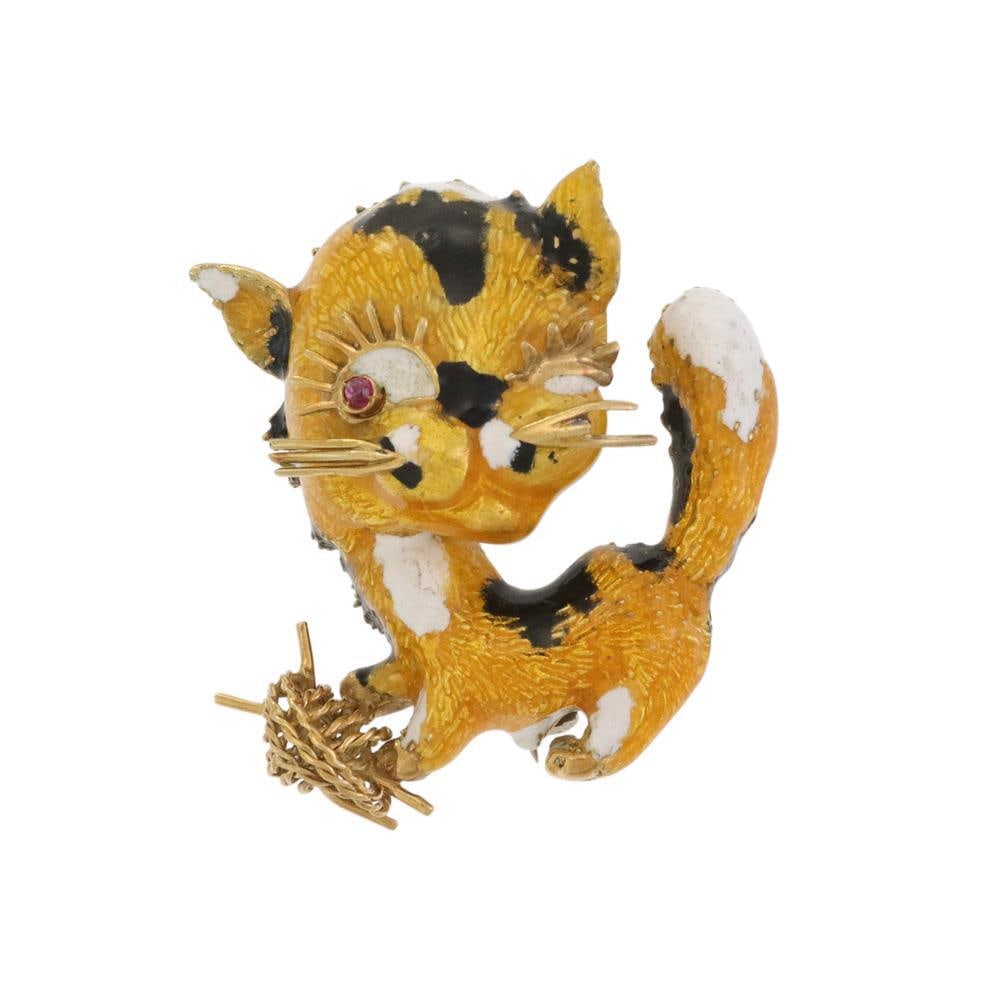 18k Yellow Gold Cat Brooch with Enamel Pink Sapphire Eye: 18k Yellow Gold Cat Brooch with Enamel Pink Sapphire Eye This delightful brooch showcases a charming full figure cat designed in 18k yellow gold, adorned with vibrant yellow, white, and black enamel. 