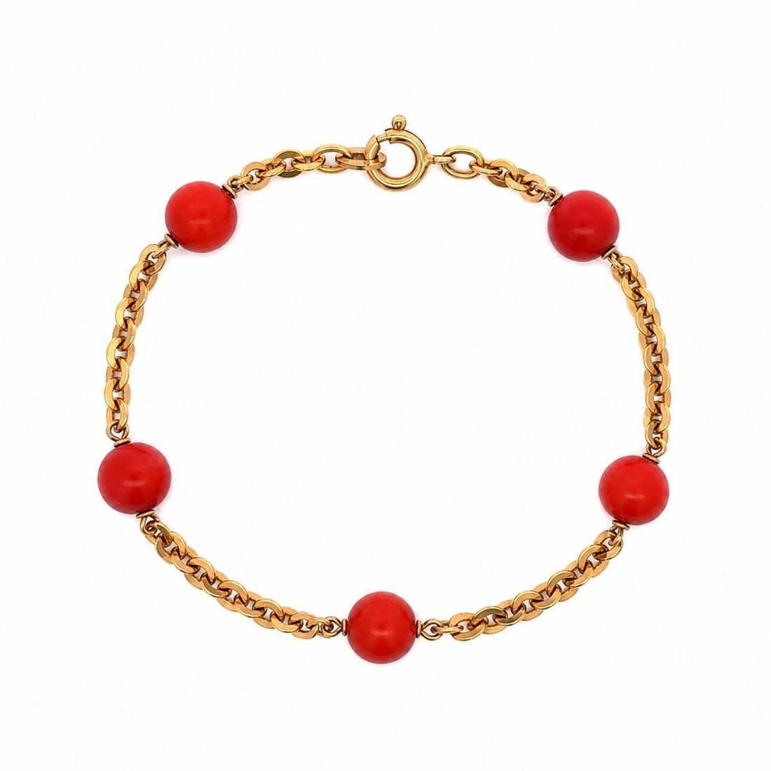 UnoAErre coral bead station bracelet in 18k yellow gold: UnoAErre coral bead station bracelet in 18k yellow gold Vintage bracelet featuring five natural genuine coral round bead stations set in solid 18k yellow gold with a flat cable link design and spring 