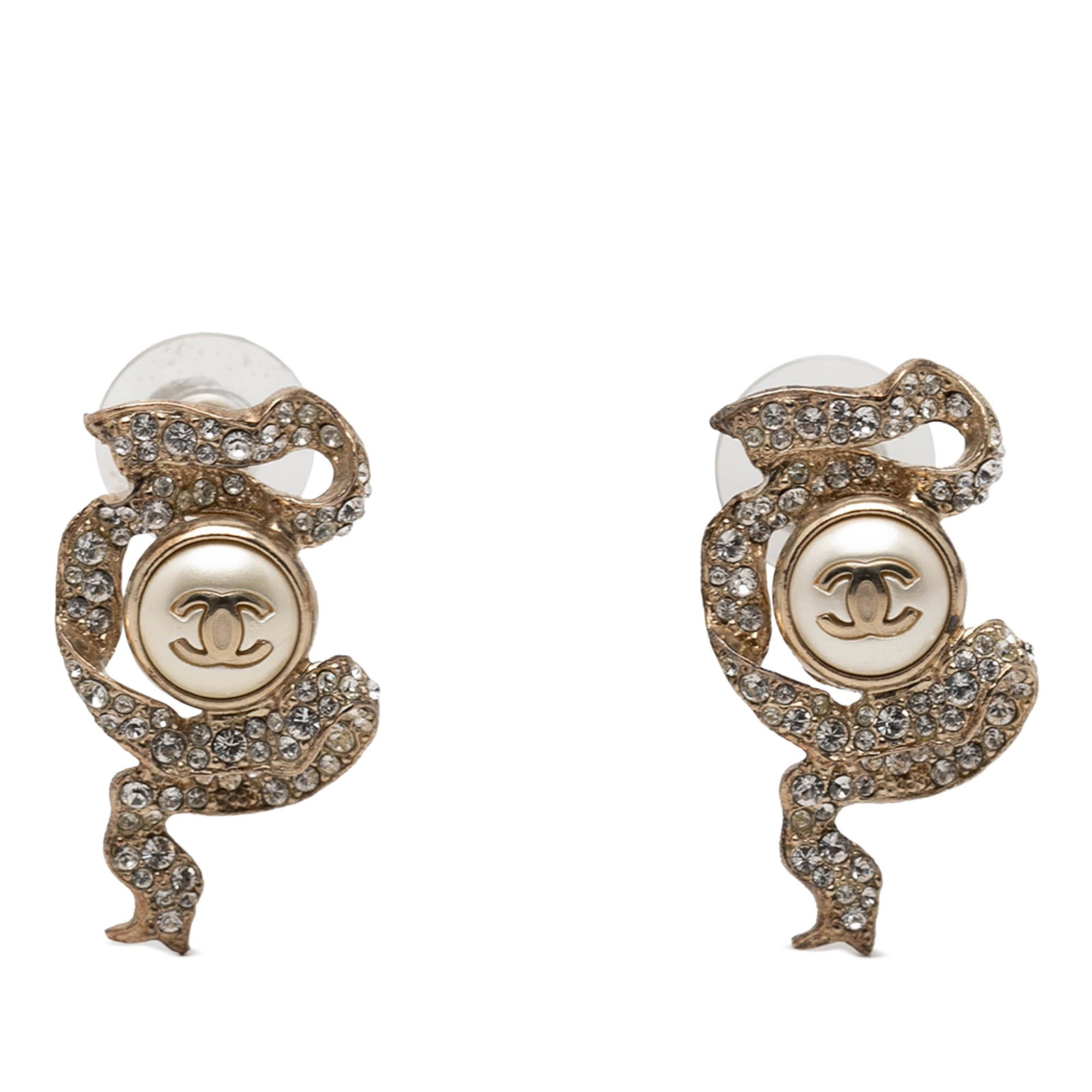 Chanel gold plated faux pearl strass ribbon earrings: Chanel gold plated faux pearl strass ribbon earrings These Chanel earrings showcase a gold-tone metal design accented with faux pearls and strass embellishments in the iconic CC ribbon motif. Featurin