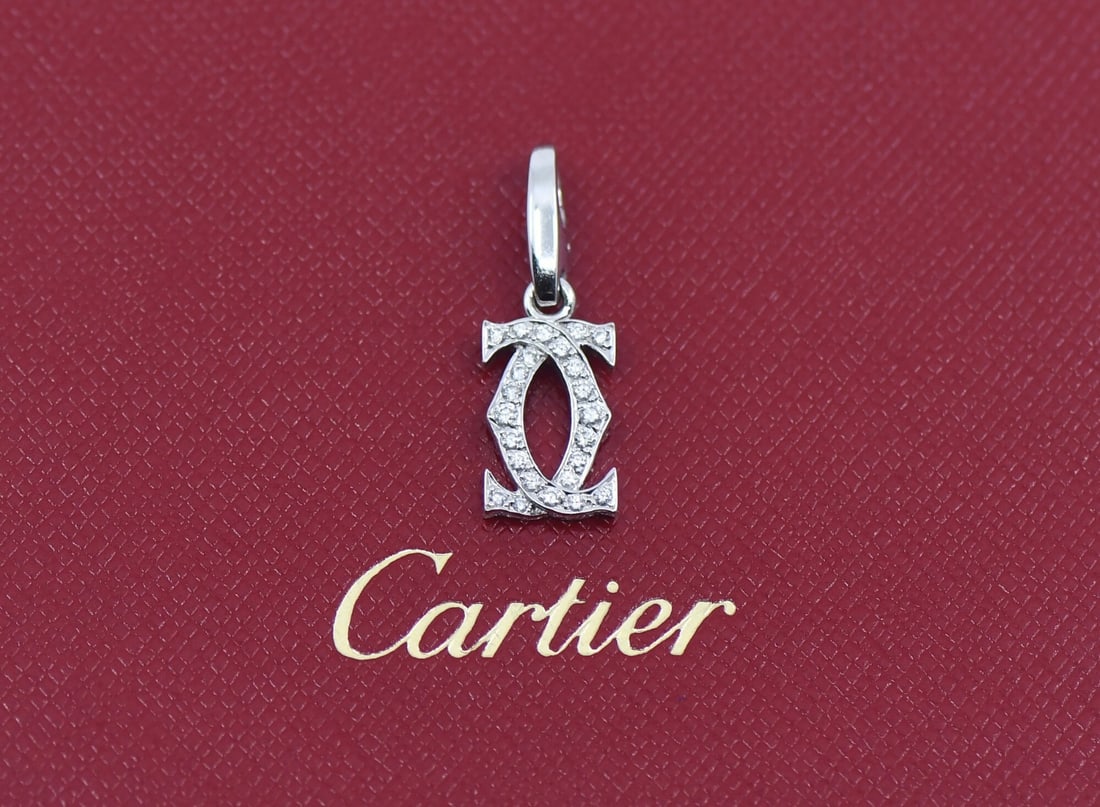 Cartier Diamond Double C 18K White Gold Pendant: Cartier Diamond Double C 18K White Gold Pendant This Cartier Double C pendant features a refined design crafted from 18K white gold and adorned with sparkling diamonds. Made in France, the pendant mea