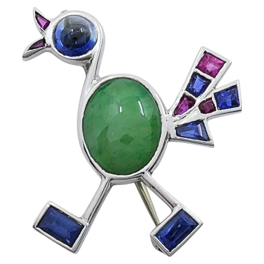 Mid Century 14k White Gold Bird Brooch with Multigemstones: Mid Century 14k White Gold Bird Brooch with Multigemstones Vintage modernist bird brooch crafted in 14k white gold and set with a central oval green cabochon and bright geometric gemstone accents. The