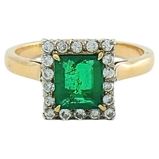 Vintage 1950s 14k Gold Emerald and Diamond Halo Ring Size 7: Vintage 1950s 14k Gold Emerald and Diamond Halo Ring Size 7 This vintage emerald ring is crafted in 14k gold and features a square-shaped bright green emerald at the center, surrounded by a halo of di