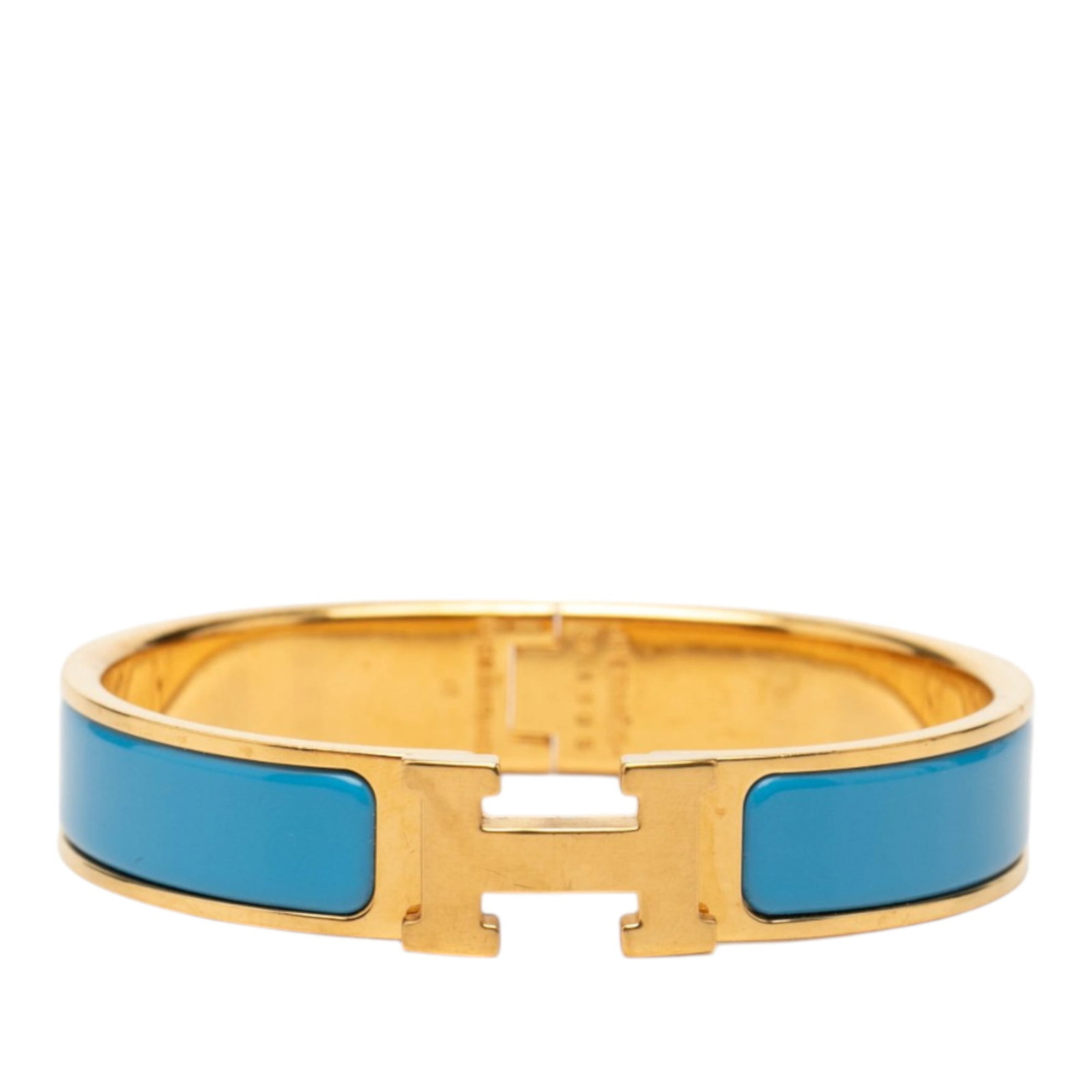 Hermes Clic H PM Narrow Enamel Bracelet: Hermes Clic H PM Narrow Enamel Bracelet Hermes Narrow Enamel Clic H Bracelet PM featuring an enamel body with gold-plated metal accents and a metal clasp closure. The bracelet is finished in blue and 