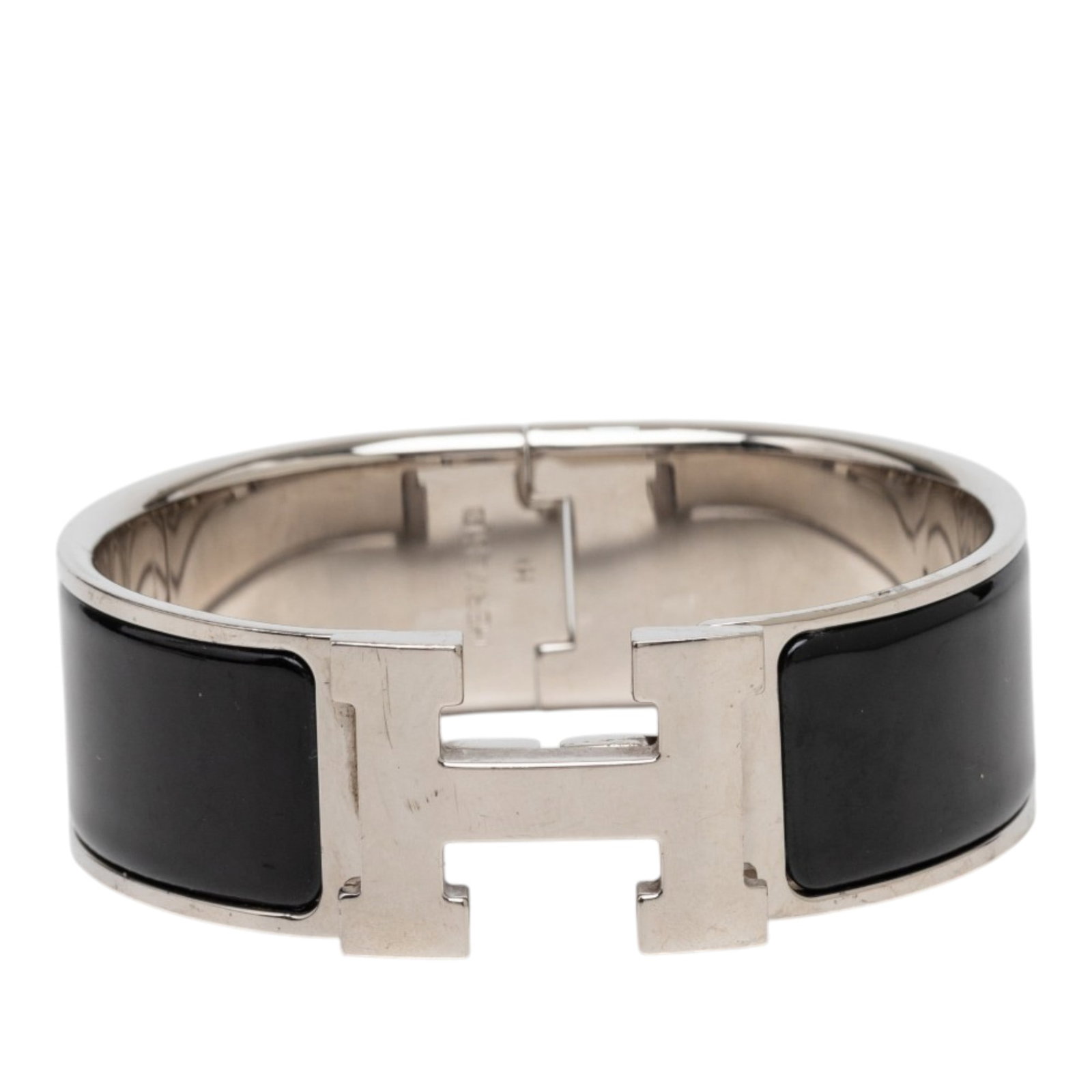 Hermes Clic Clac H PM Wide Enamel Bracelet Black: Hermes Clic Clac H PM Wide Enamel Bracelet Black Hermes Wide Enamel Clic Clac H Bracelet PM featuring an enamel body with palladium-plated metal and an H turn-lock closure. This costume bracelet is ma