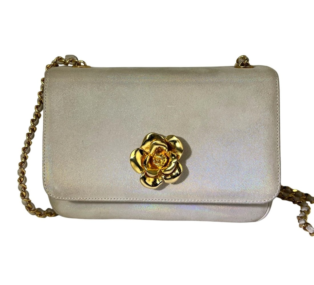 Chanel Camellia Floral Iridescent Suede Shoulder Bag: Chanel Camellia Floral Iridescent Suede Shoulder Bag This vintage Chanel Camellia shoulder bag features an elegant rectangular shape with a distinctive iridescent floral pattern. Crafted with a white