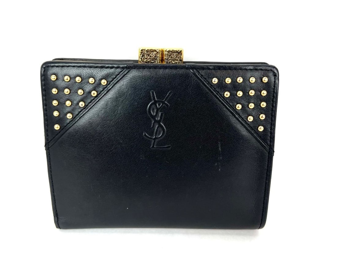 Saint Laurent Cassandre Studded Black Lambskin Vintage Bifold Wallet: Saint Laurent Cassandre Studded Black Lambskin Vintage Bifold Wallet This Saint Laurent Cassandre wallet features a classic bifold design crafted from lambskin leather in solid black. Accented with st