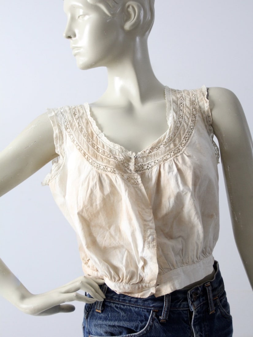 Victorian Antique Cotton Corset Cover with Lace Detailing: Victorian Antique Cotton Corset Cover with Lace Detailing This exquisite antique corset cover is a stunning example of Victorian craftsmanship. Made from soft cotton, it showcases delicate lace detail