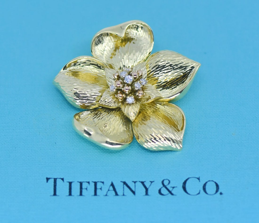 Tiffany & Co 18K Yellow Gold Flower Brooch with Diamonds: Tiffany & Co 18K Yellow Gold Flower Brooch with Diamonds Vintage Tiffany & Co. diamond flower brooch in 18K yellow gold. The piece features a flower design with natural round diamonds and is signed. P