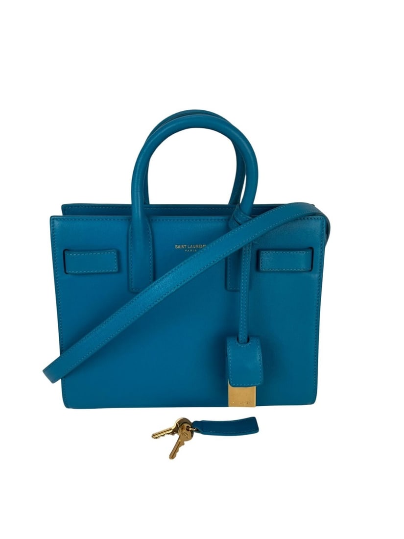 Saint Laurent Sac De Jour Blue Leather Crossbody Handbag with Gold Hardware: Saint Laurent Sac De Jour Blue Leather Crossbody Handbag with Gold Hardware Elevate your accessory collection with the Saint Laurent Sac De Jour Crossbody Hand Bag. This stylish small bag features a c