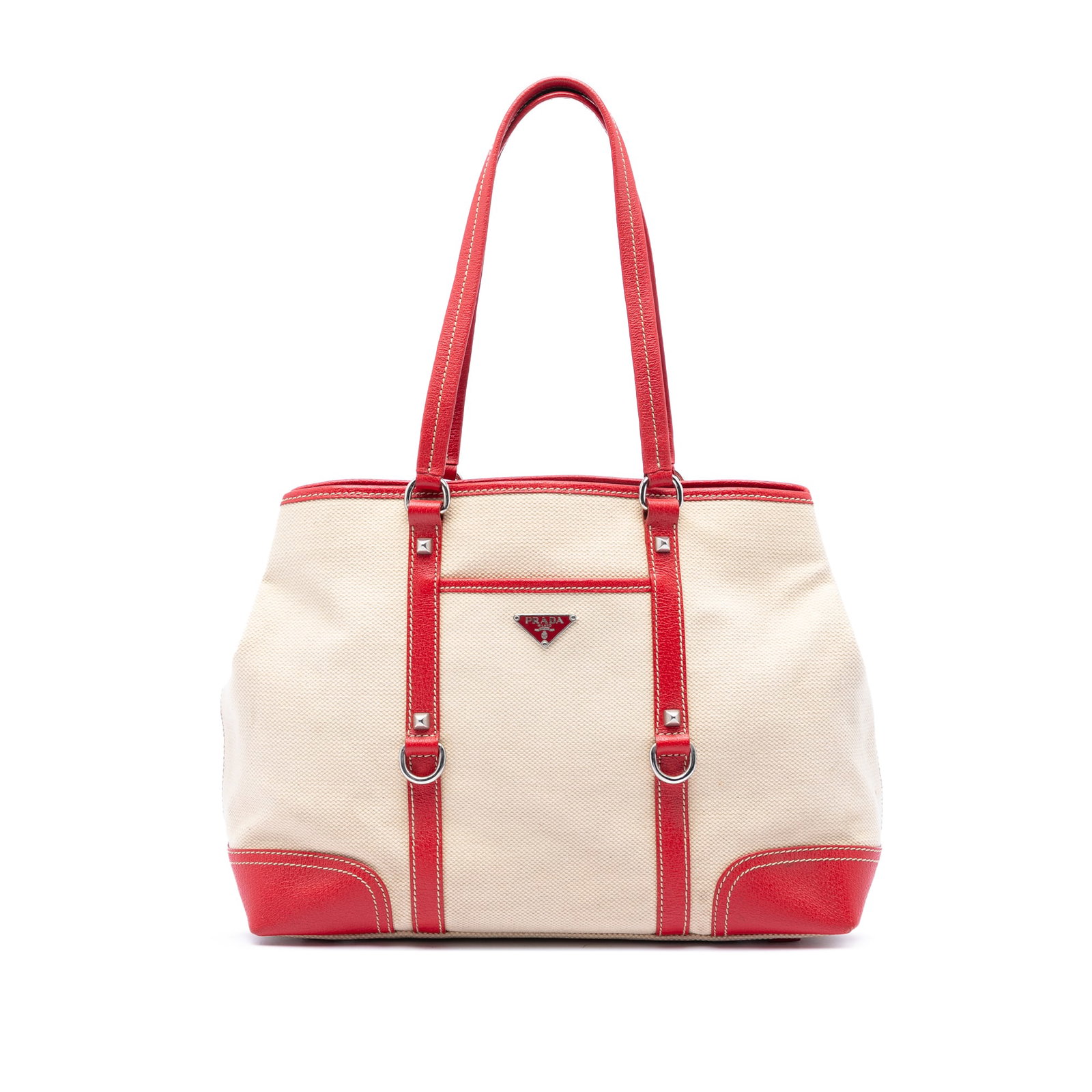 Prada studded canvas tote bag with leather trim front pocket: Prada studded canvas tote bag with leather trim front pocket Prada tote bag with a canvas body and leather trim, featuring flat leather handles, an open top with magnetic snap closure, an exterior fro