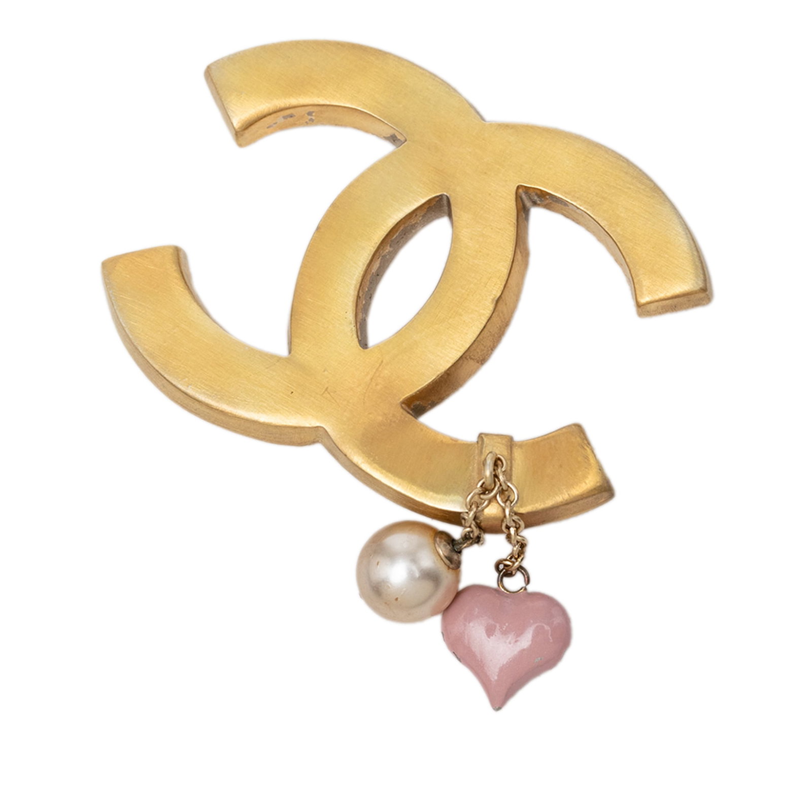 Chanel CC faux pearl heart enamel gold tone brooch: Chanel CC faux pearl heart enamel gold tone brooch Chanel CC brooch with faux pearl and heart enamel details on a gold tone metal body. This costume jewelry piece is finished with a back pin closure. 