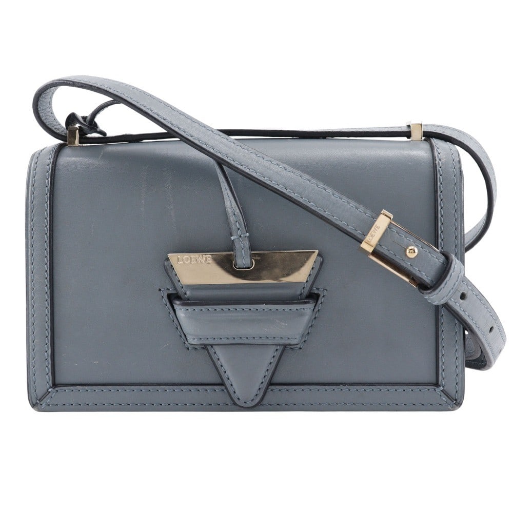 Loewe Barcelona blue leather shoulder bag: Loewe Barcelona blue leather shoulder bag This Loewe Barcelona shoulder bag for women features blue leather construction with a compact design. It shows minor signs of wear including slight scratches,