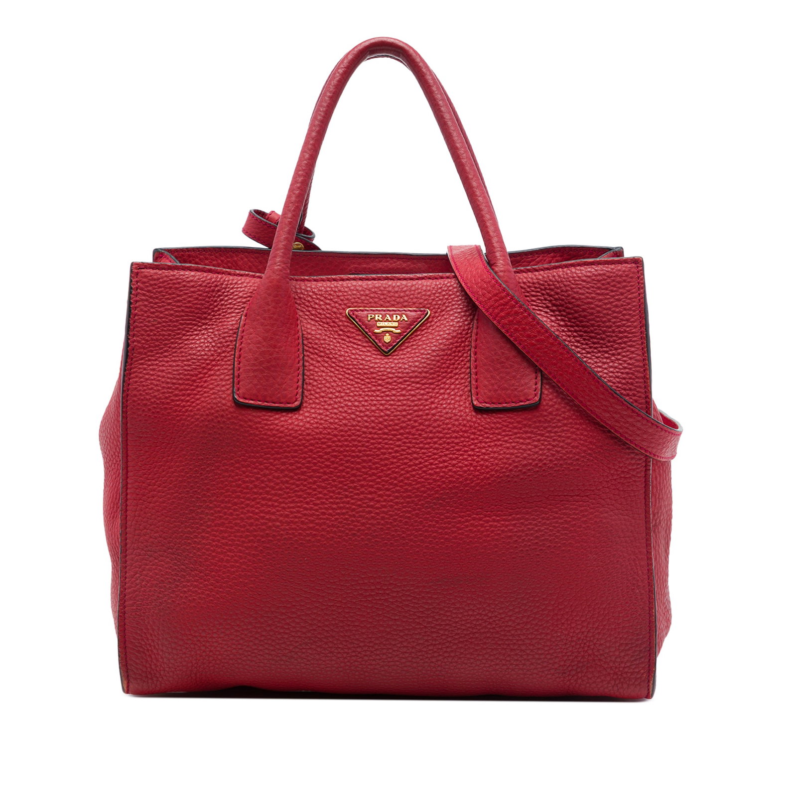 Prada Vitello Daino leather satchel with strap in red: Prada Vitello Daino leather satchel with strap in red Prada Vitello Daino Open Convertible Tote in red leather with rolled handles, a detachable flat strap, and an open top with magnetic snap closure.