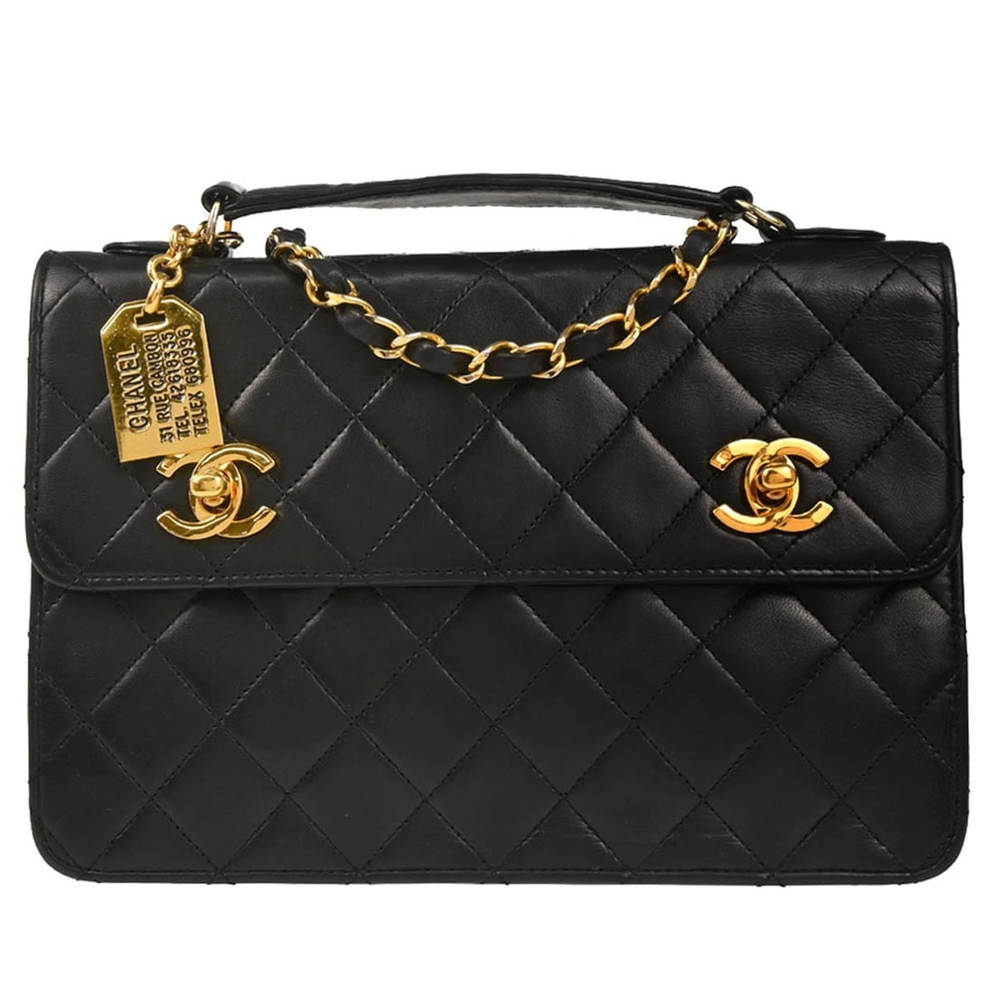 CHANEL CC black lambskin top handle 2way bag: CHANEL CC black lambskin top handle 2way bag Chanel black lambskin 2way handbag made in France. This medium-sized top handle bag features a leather lining, logo accent, and a non-adjustable strap. It 
