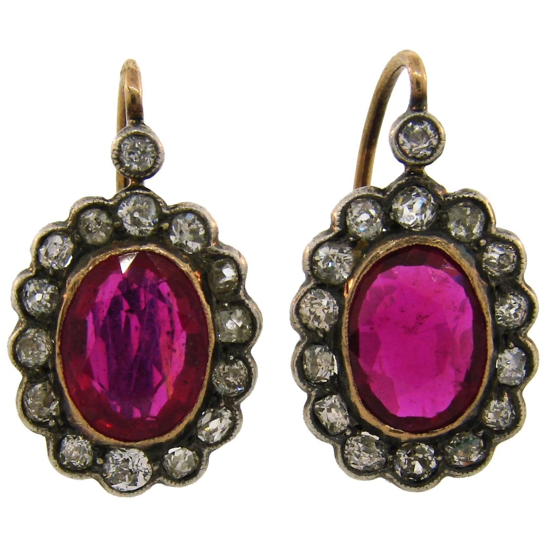 14k Yellow Gold Silver Cluster Earrings with Ruby and Diamond Drops: 14k Yellow Gold Silver Cluster Earrings with Ruby and Diamond Drops A pair of cluster drop stud earrings featuring rubies and diamonds in a silver and 14k yellow gold setting. The earrings have mixed-