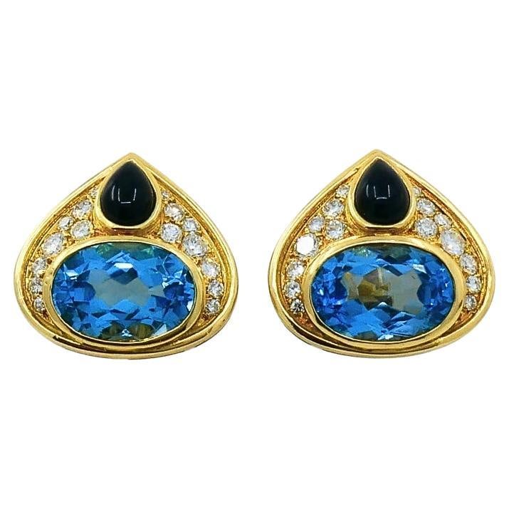 Marina B 18k Gold Clip Earrings with Topaz Onyx and Diamonds: Marina B 18k Gold Clip Earrings with Topaz Onyx and Diamonds A pair of Marina B clip-on earrings crafted in 18k gold, featuring topaz, onyx, and diamond accents. The design dates to the 1980s and pres