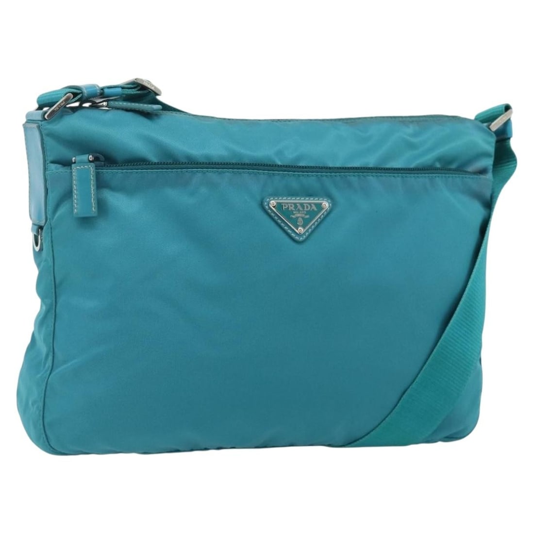 PRADA Nylon Shoulder Bag Turquoise Blue Silver Tone with Guarantee Card: PRADA Nylon Shoulder Bag Turquoise Blue Silver Tone with Guarantee Card This PRADA shoulder bag is crafted from nylon in a turquoise blue and silver color combination. It features a shoulder strap wit